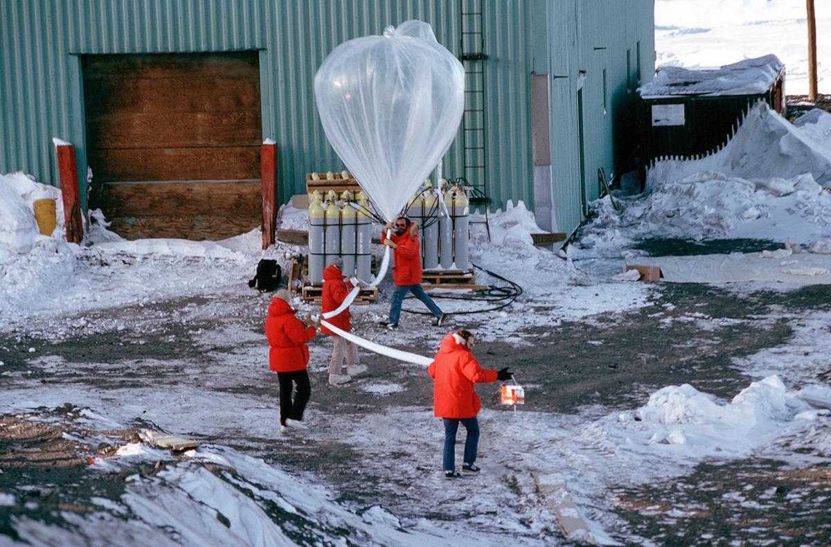 Dr. David J. Hofmann, Craig B. Sutter, Jim V. Hereford, and Terry L. Deshler prepare to release a weather balloon as part of a National Science Foundation study of the atmosphere’s ozone layer, October 26, 1989