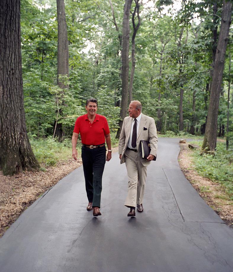 President Ronald Reagan walks with George Shultz at Camp David, Maryland, August 14, 1982